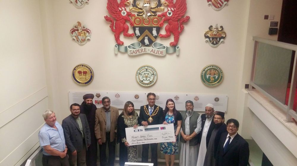 cheque for £4,259 presented to the Mayor of Oldham