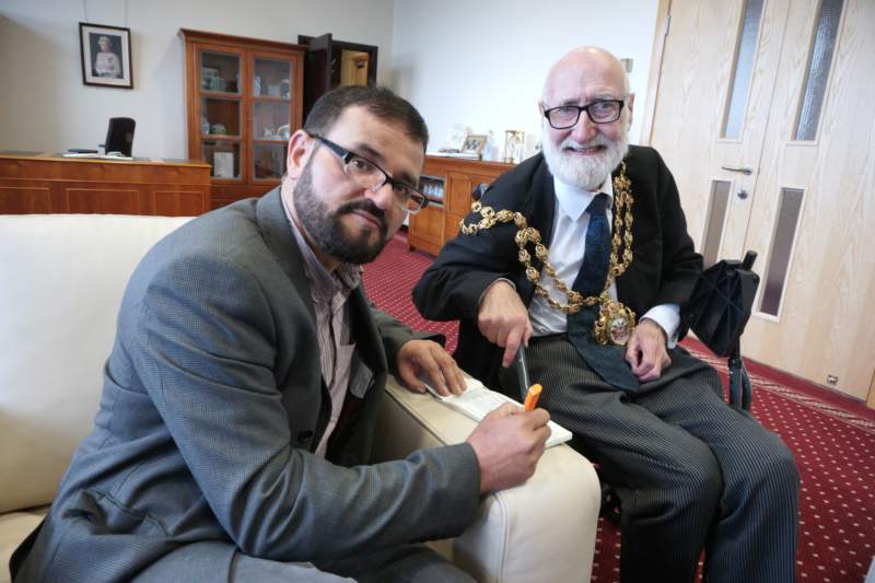 Fazal Rahim signs chq from Oldham Mosques' Council to Oldham Mayor's Charities with Mayor Derek Heffernan
